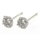 A pair of cluster stud earrings in an 18 k. white gold setting and brilliant cut diamonds