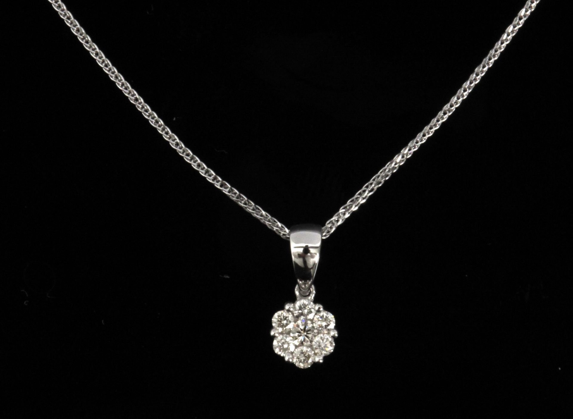 A diamond cluster pendant in an 18k white gold setting