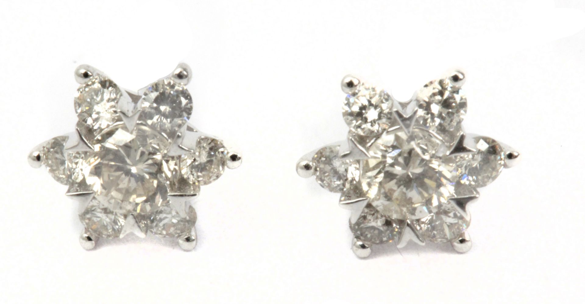A pair of star shaped stud earrings in an 18k. white gold setting with brilliant cut diamonds