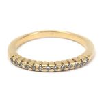 A diamond eternity diamond ring with an 18 k. yellow gold setting