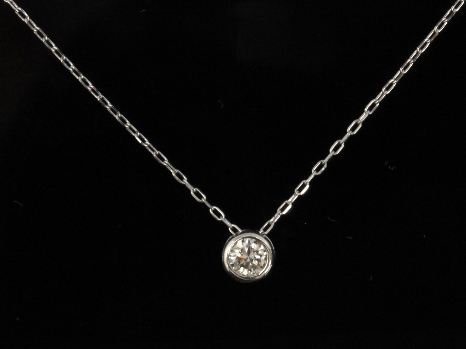 A brilliant cut diamond pendant in a platinum setting