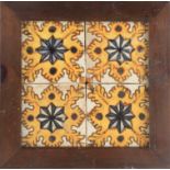 An 17th century wallplaque with four Catalan showing tiles