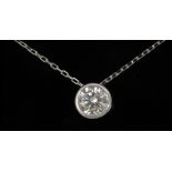 A diamond pendant with an 18k. white gold bezel setting and platinum chain