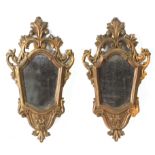 A pair of carved and gilt wood Isabelino cornucopia mirrors