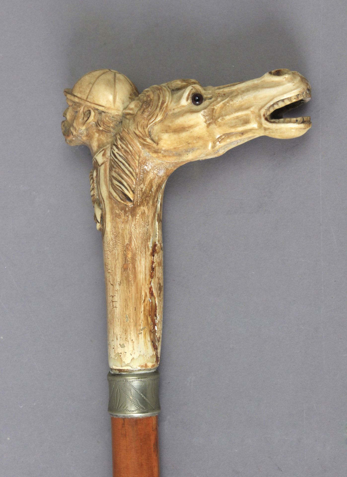 A 19th century English fruit wood walking cane with a carved horn handle