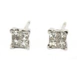 A pair of square stud earrings in an 18 k. white gold setting and brilliant cut diamonds