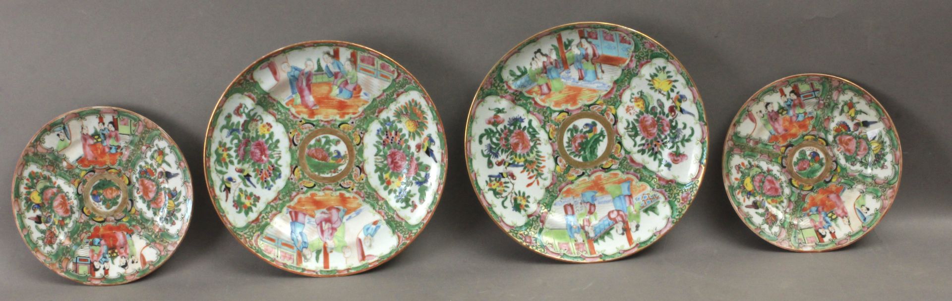 A set of four Canton Famille Rose porcelain plates, late 19th century-early 20th century