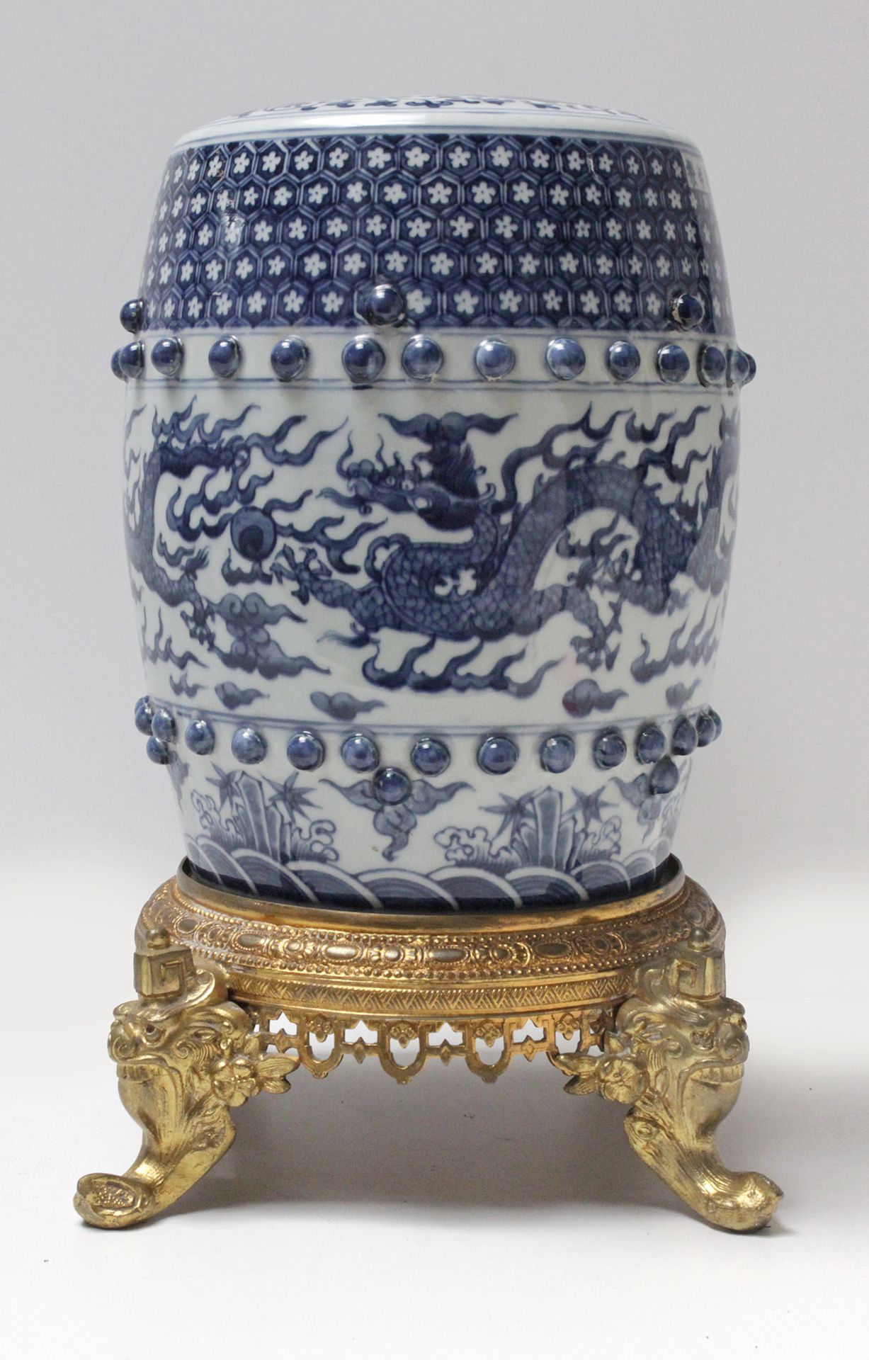 A 20th century Chinese wrist rest in blue and white porcelain with a gilt bronze garniture