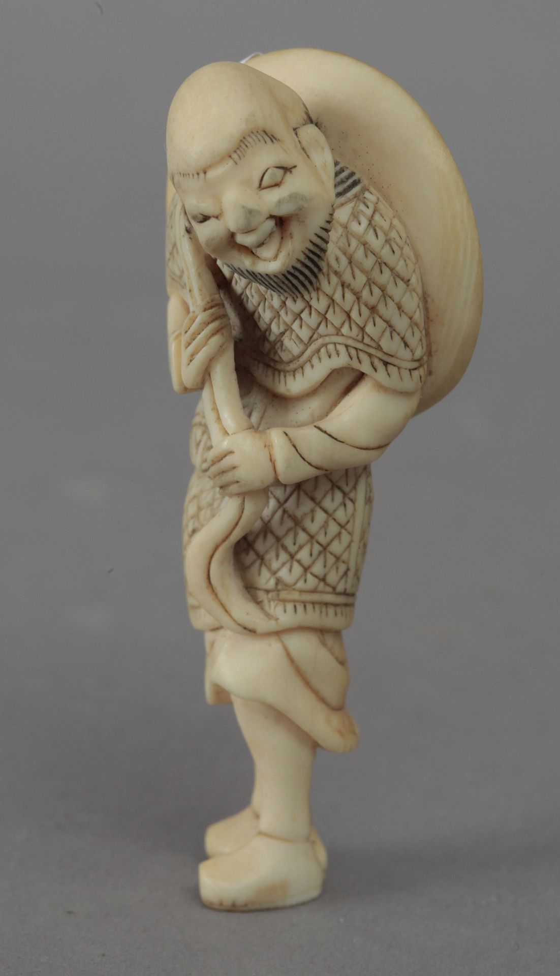 Mid 18th century Japanese school. A carved ivory netsuke depicting a Sennin