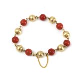 A 20th century 18k. yellow gold and coral beads bracelet