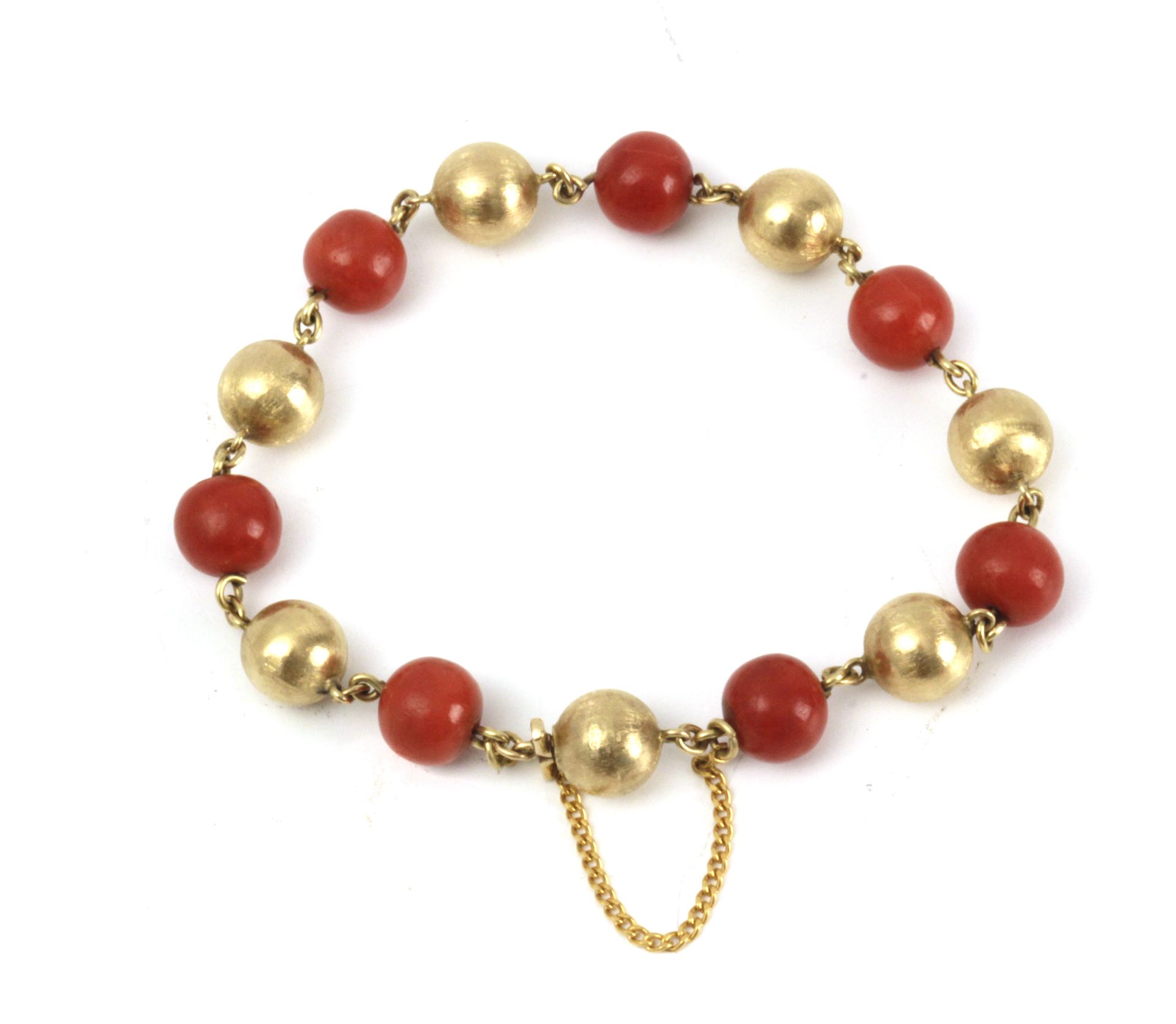 A 20th century 18k. yellow gold and coral beads bracelet