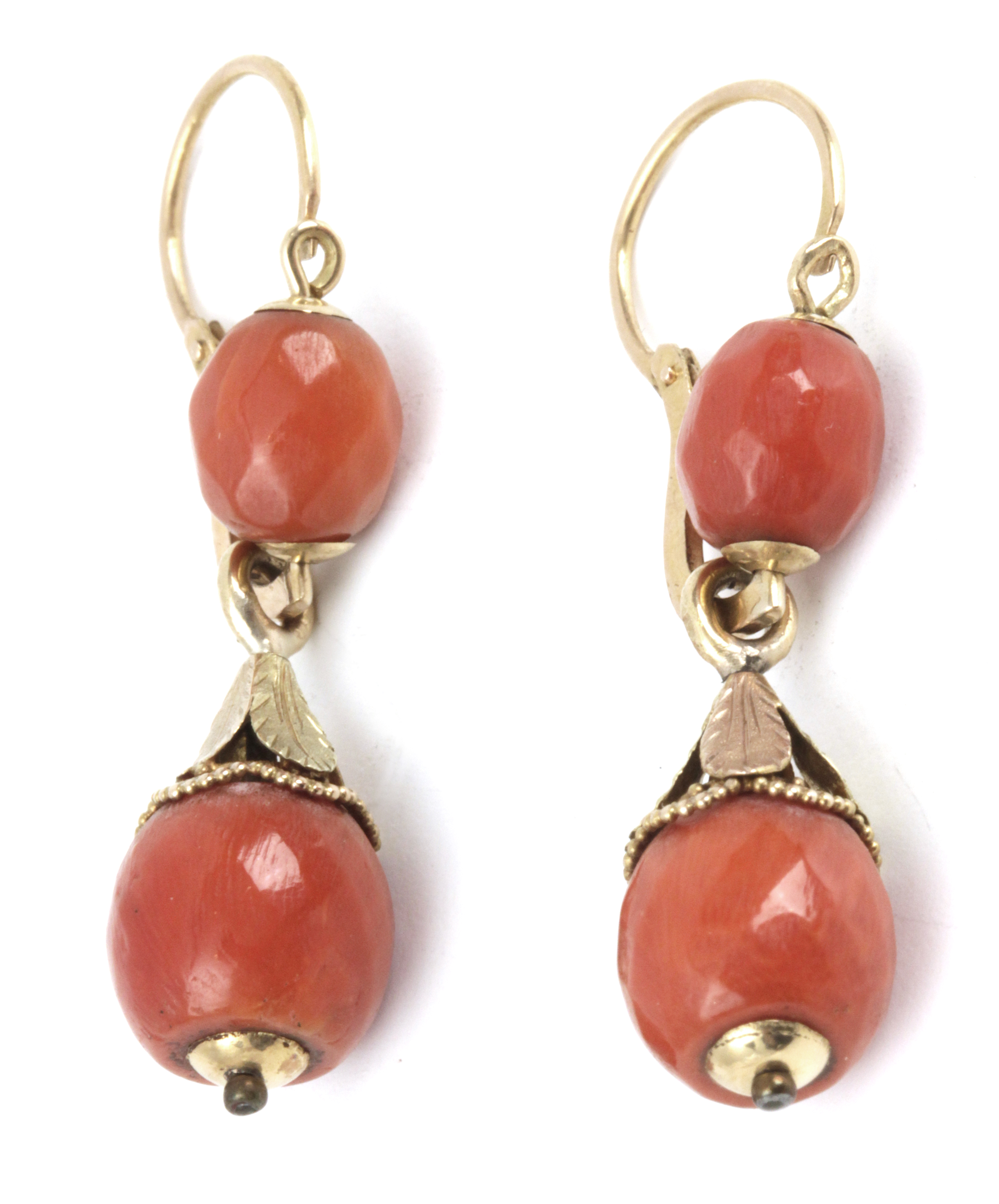 A pair of first half of 20th century coral earrings with an 18k. yellow gold setting