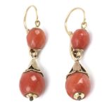 A pair of first half of 20th century coral earrings with an 18k. yellow gold setting