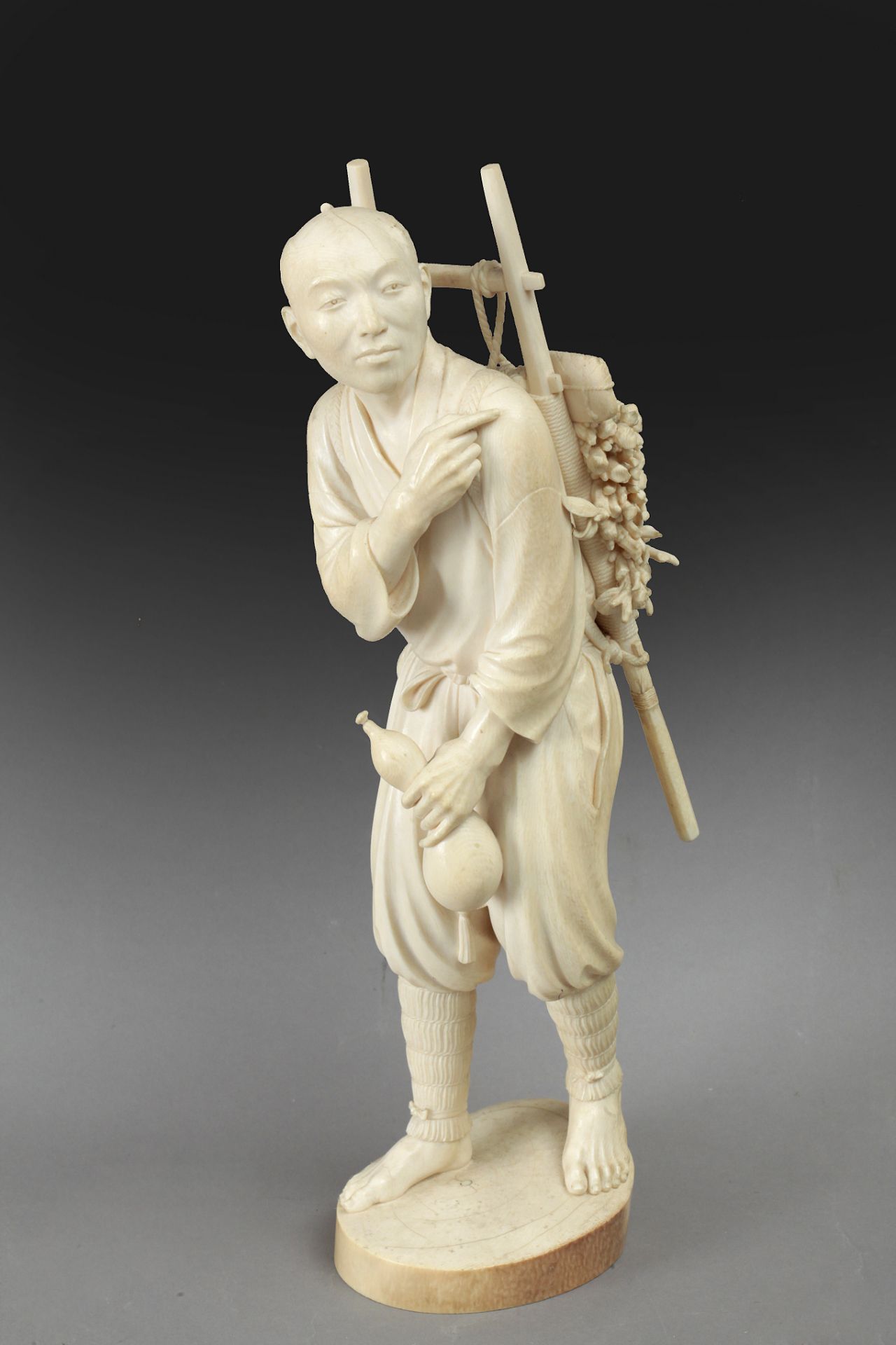 First third of 20th century Japanese school. A carved ivory okimono depicting a lumberjack