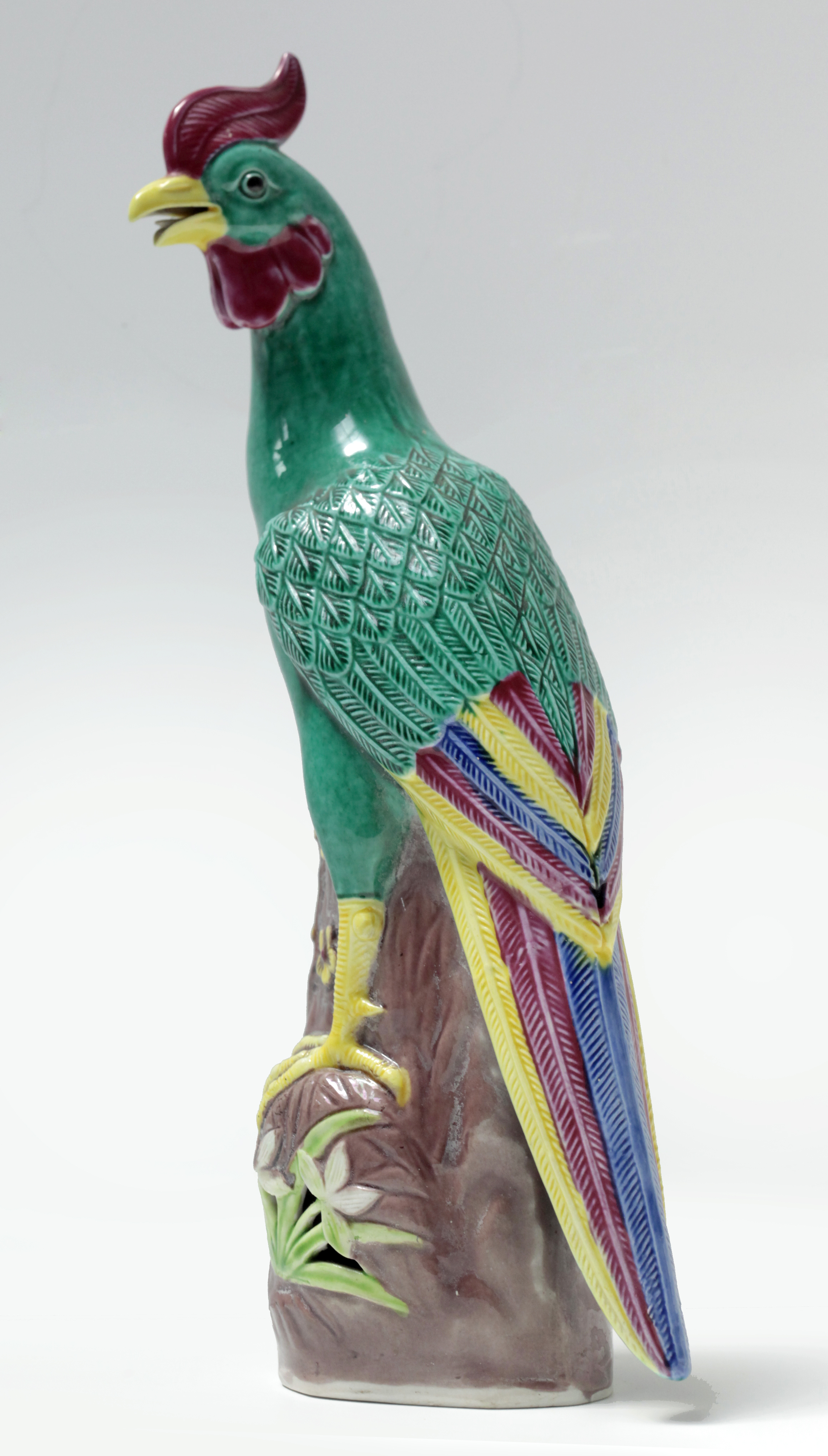 20th century Chinese school. A porcelain figure of a tropical bird