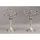 A pair of first half of 20th century Empire style silver candelabras