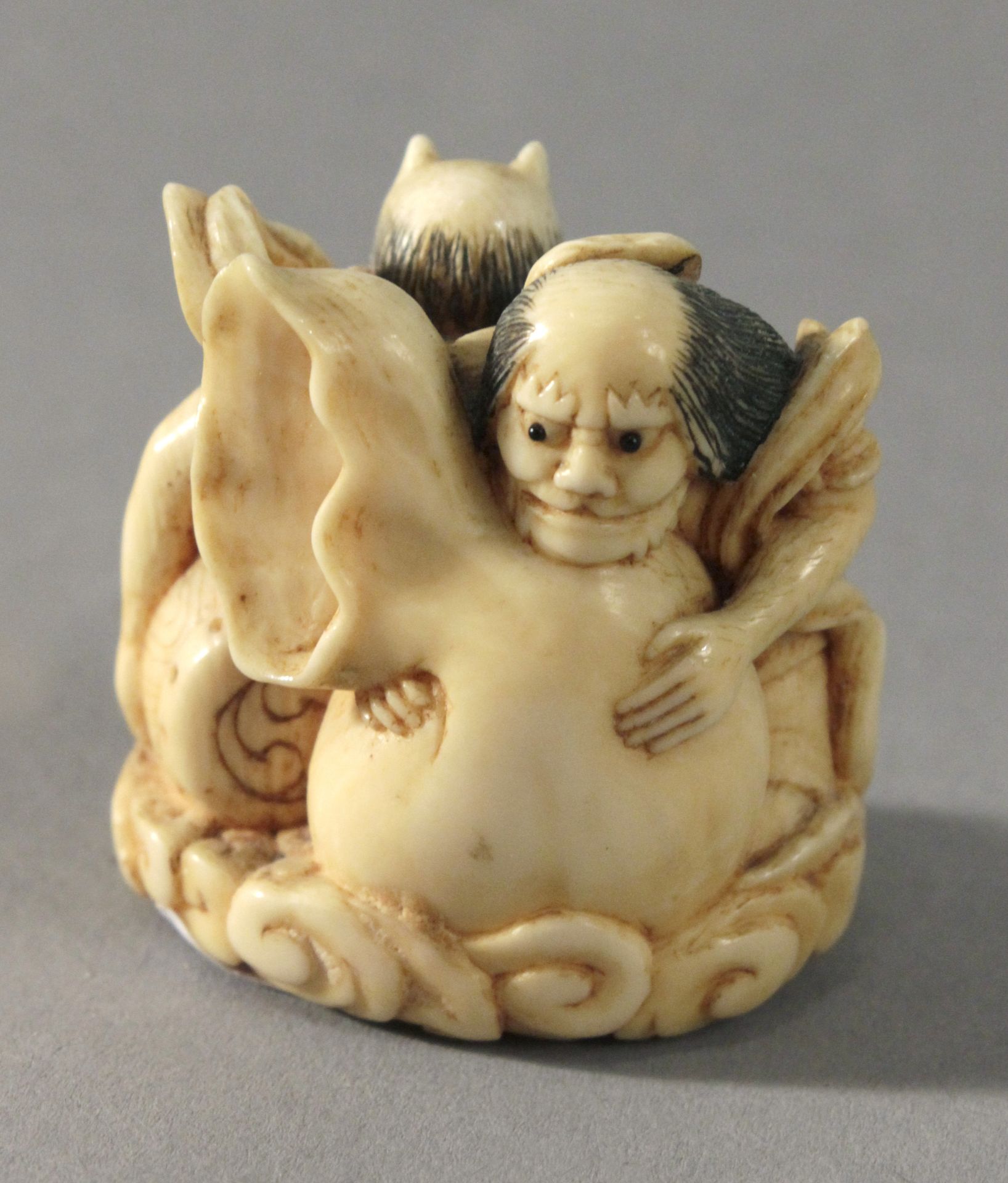 19th century Japanese school. A carved ivory netsuke depicting Oni playing a drum - Image 2 of 2
