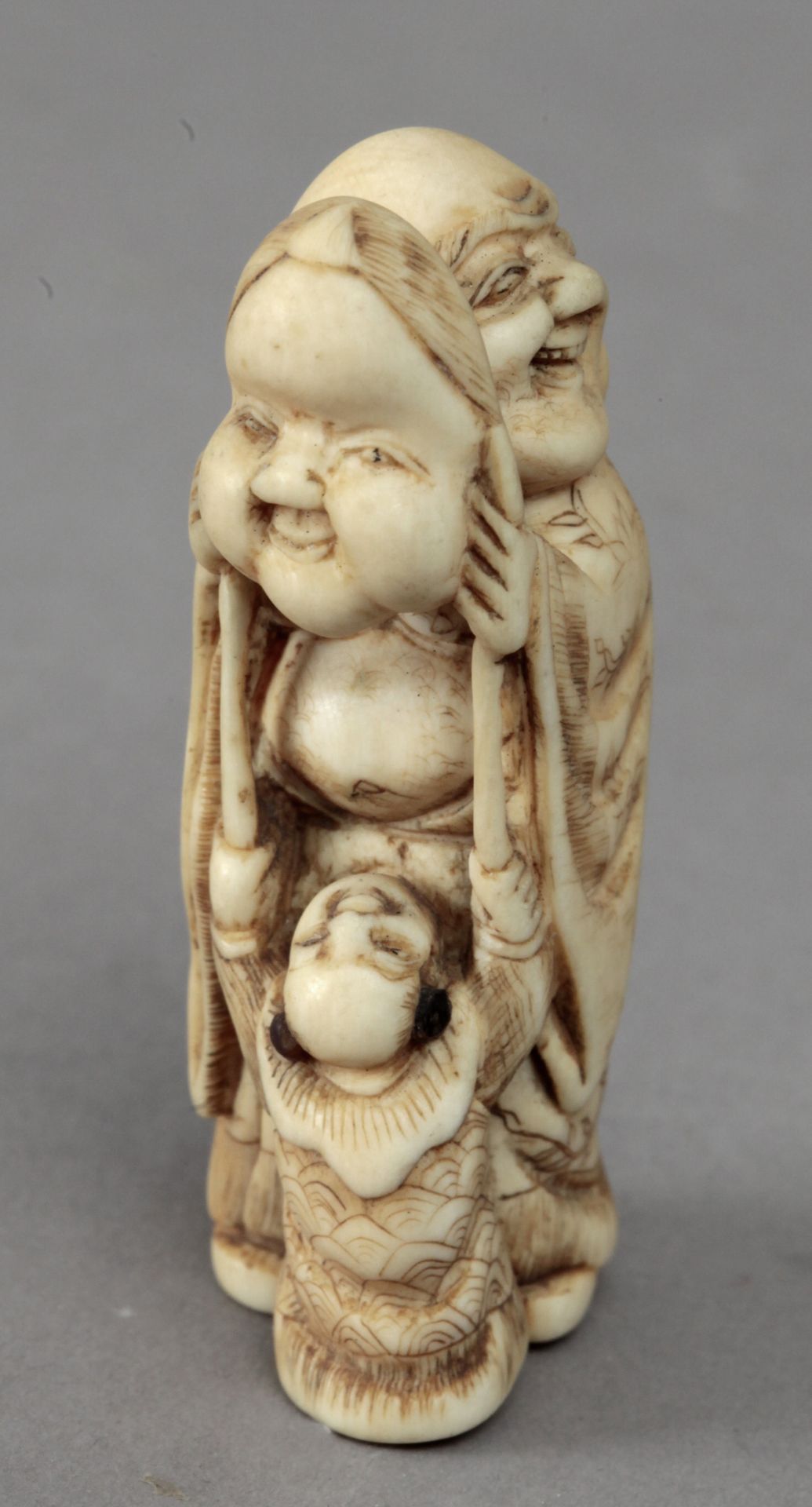 Early 19th century Japanese school. A carved ivory netsuke depicting a Hotei