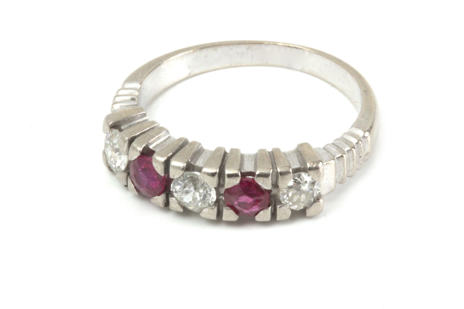 A five stone diamond and ruby ring with an 18k. gold setting
