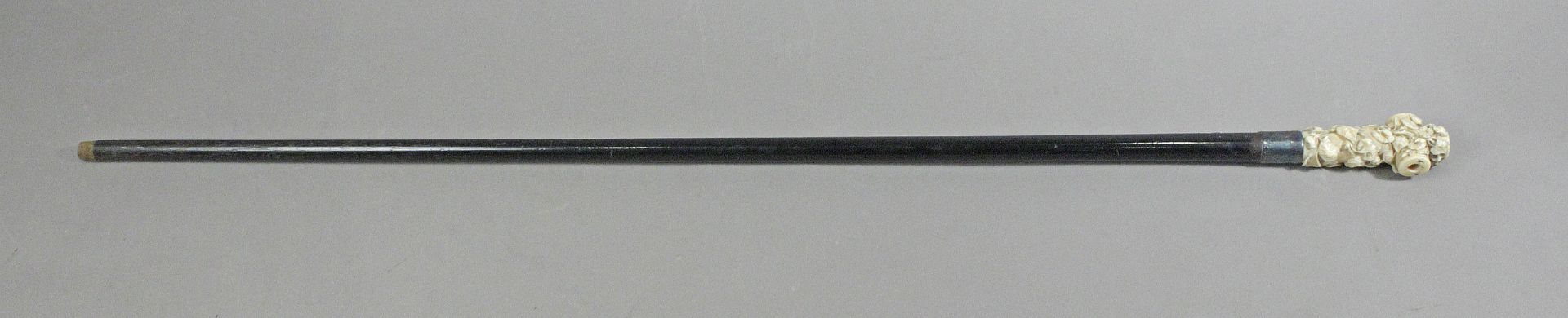 A 19th century, lacquered wood and ivory walking cane