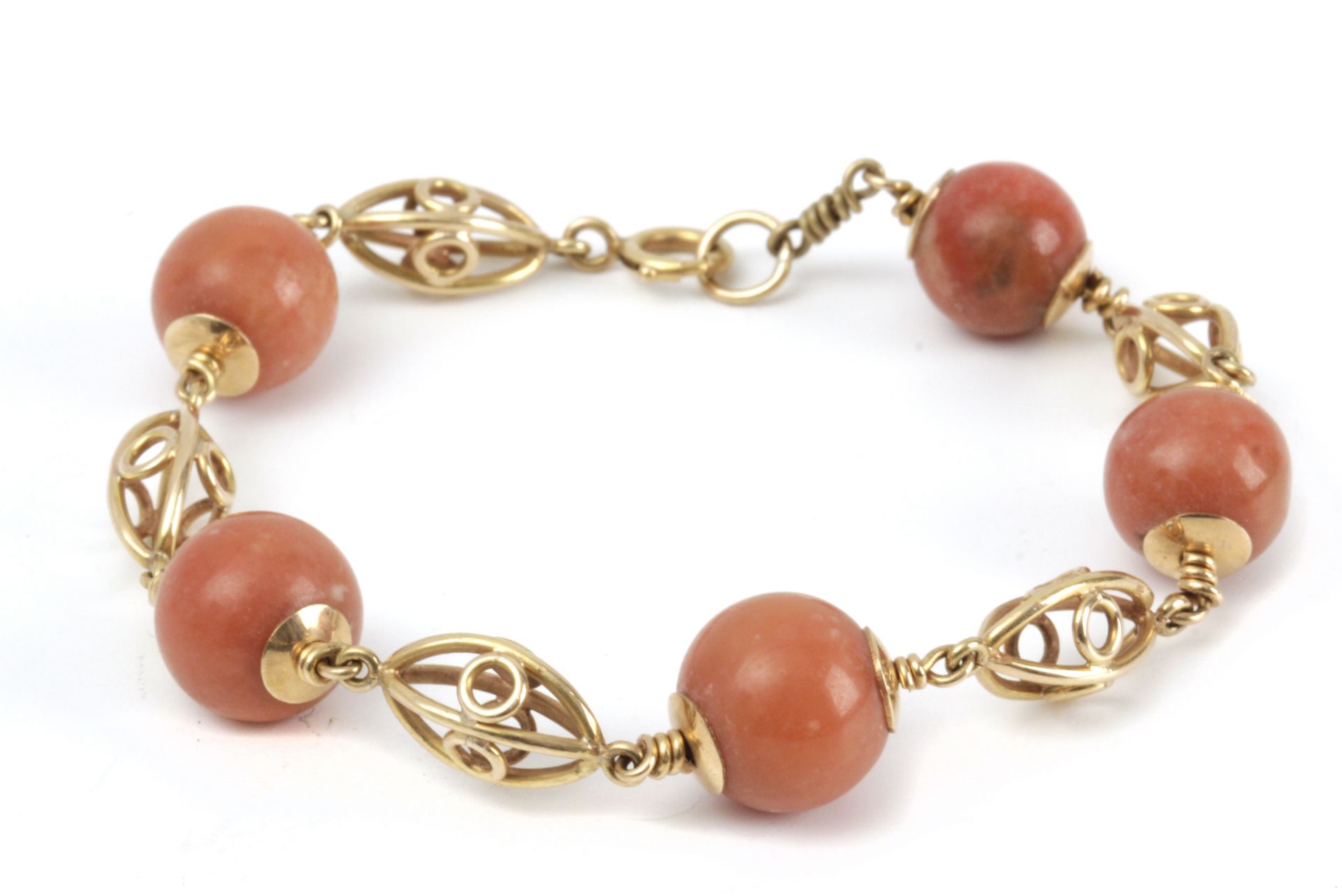 A mid 20th century 18k. yellow gold and coral bracelet