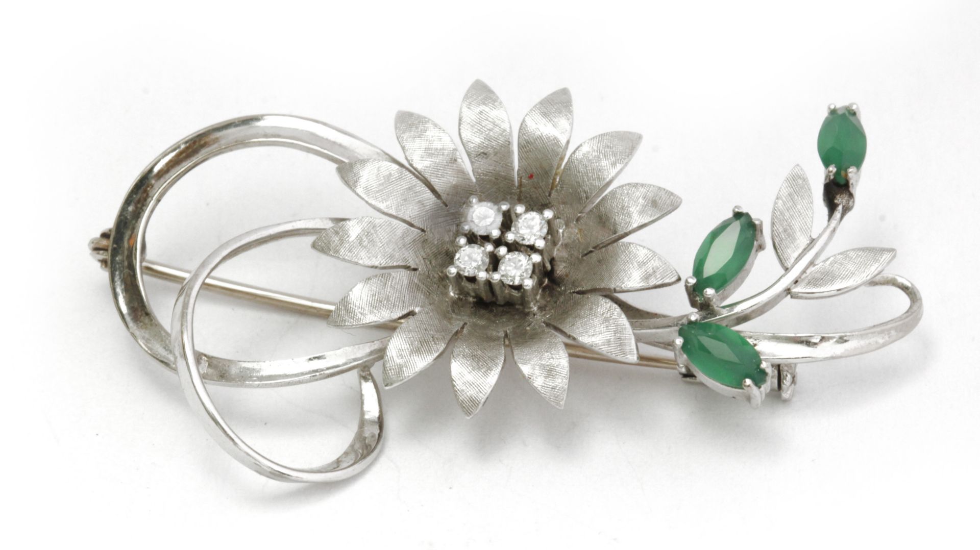 A diamond and chrysoprase flowery brooch circa 1960-1969 with an 18k. white gold setting