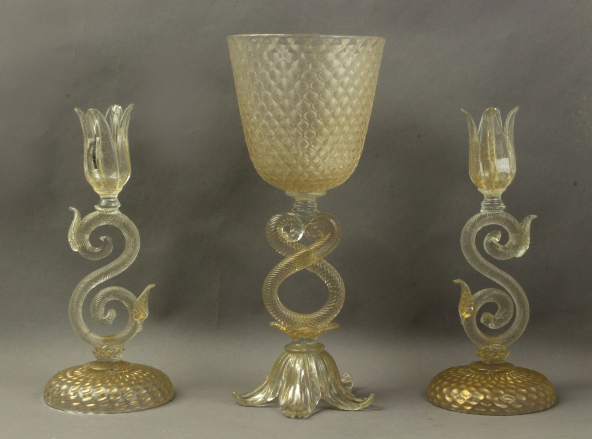 A pair of 20th century Italian candlesticks and a centrepiece in Murano glass