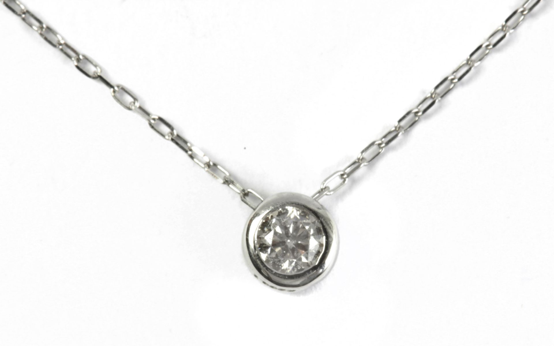 A 0,10 ct. brilliant cut diamond solitaire pendant with a platinum setting