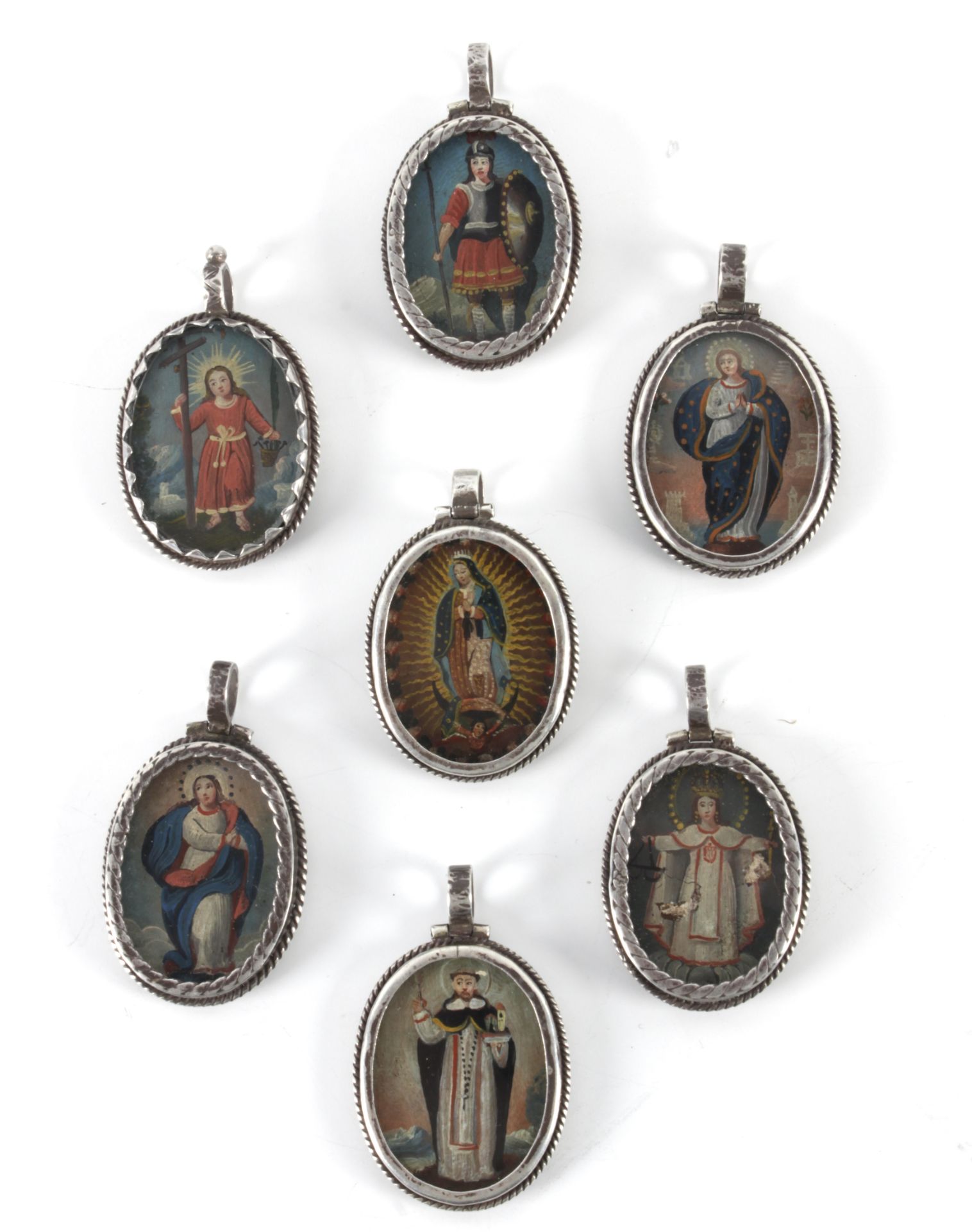 A collection of seven colonial reliquary pendants in mexican silver