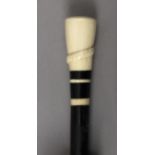 A 19th century European walking cane in carved ebony and ivory