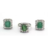A set of emerald and brilliant cut diamond cluster ring and earrings with a platinum setting