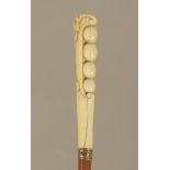 A 19th century European walking cane in carved fruitwood and ivory