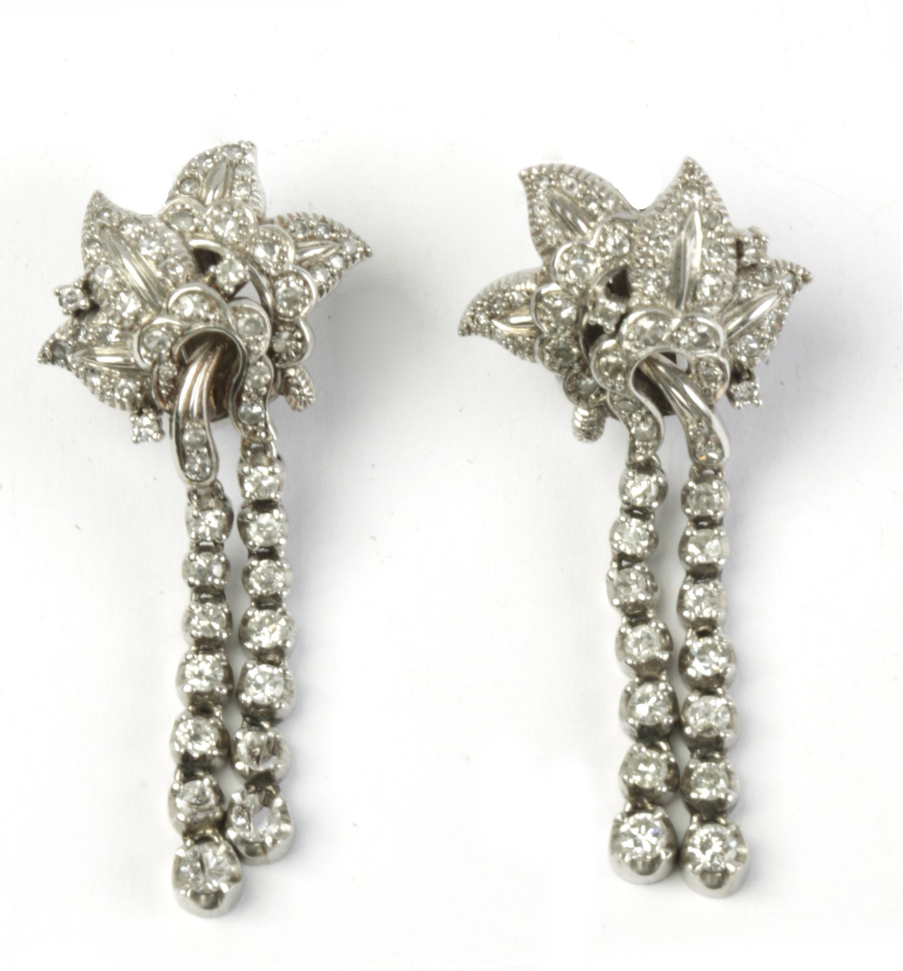 A pair of diamond and platinum long earrings circa 1960