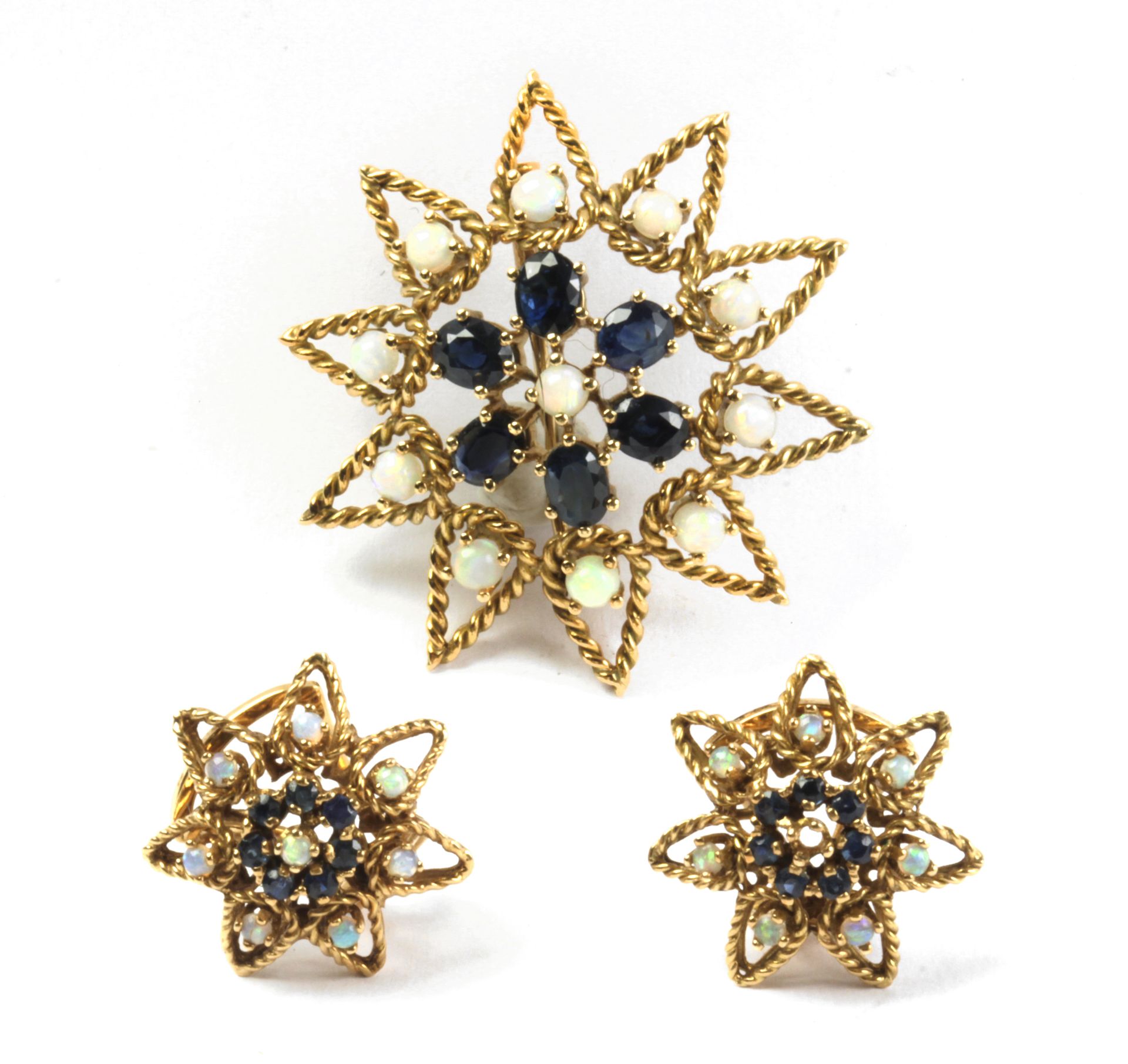 A sapphire and precious opal set of brooch and earrings with an 18k. yellow gold setting