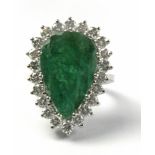 A Brazilian cut emerald and brilliant cut diamonds cluster ring circa 1960 with an 18k. white gold