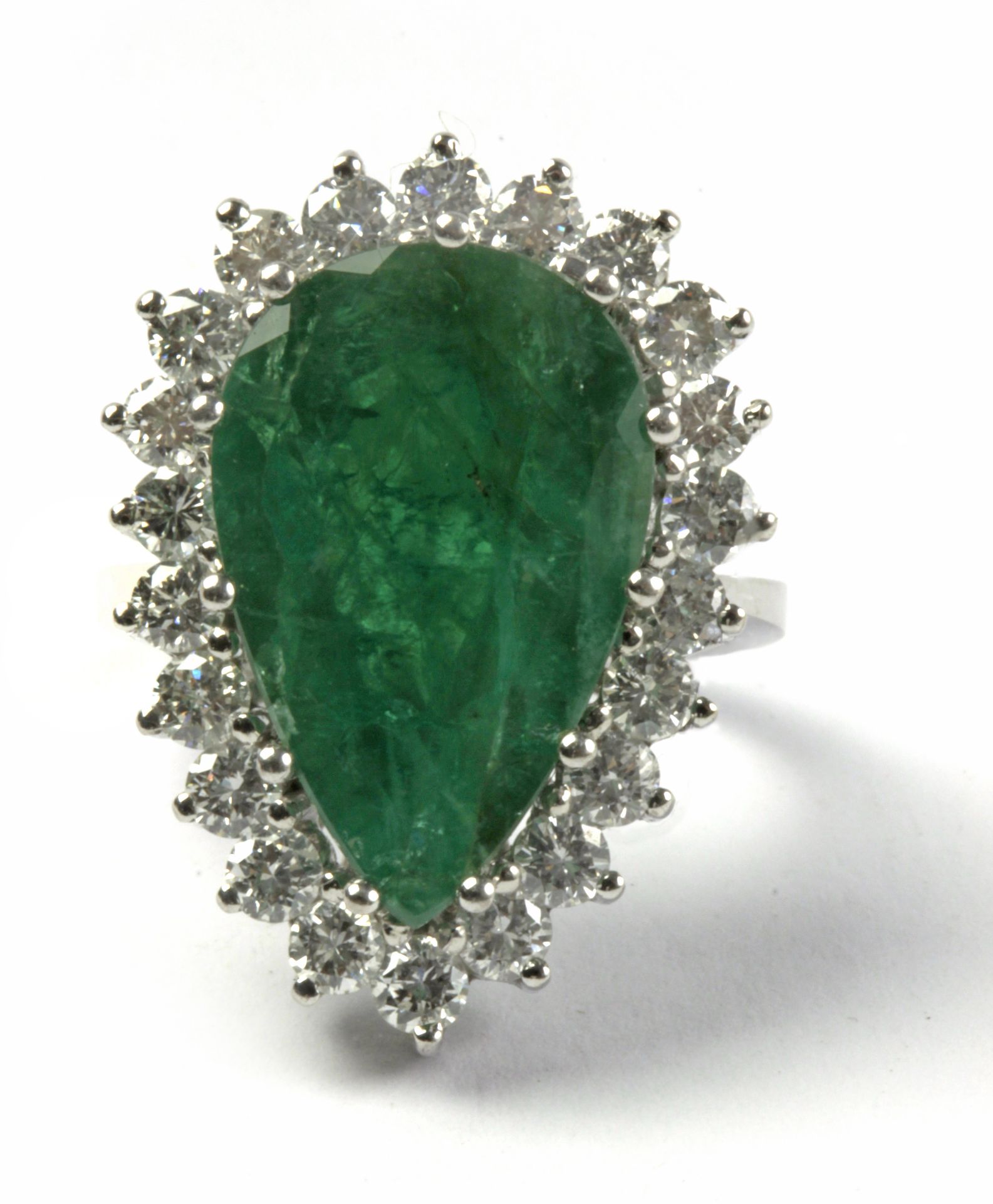 A Brazilian cut emerald and brilliant cut diamonds cluster ring circa 1960 with an 18k. white gold