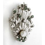 A diamond, emerald and pearl flowery brooch with a platinum setting