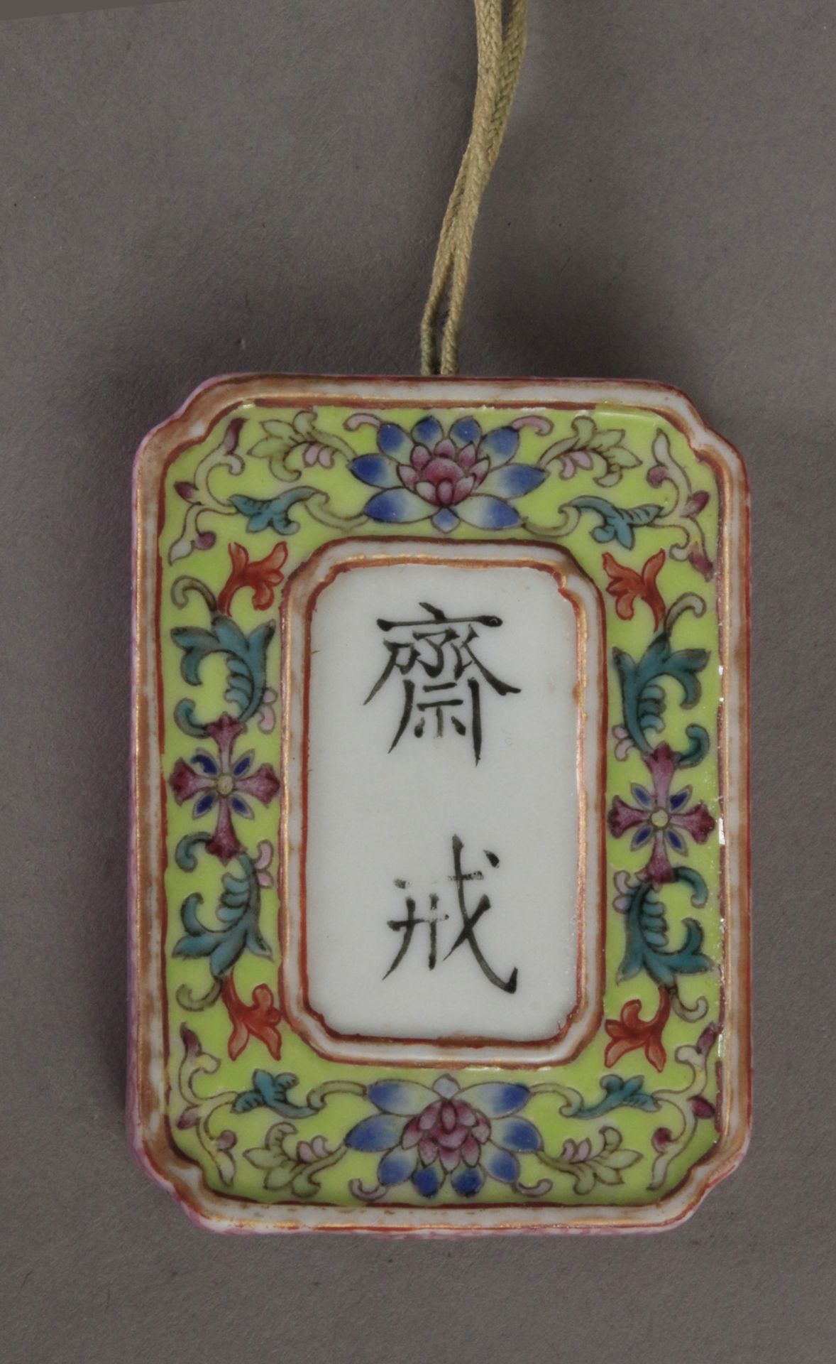 A Chinese abstinence plaque circa 1900 in Famille Rose porcelain