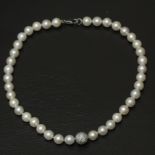 An Akoya cultured pearl necklace with a diamond and 18k. white gold details and clasp