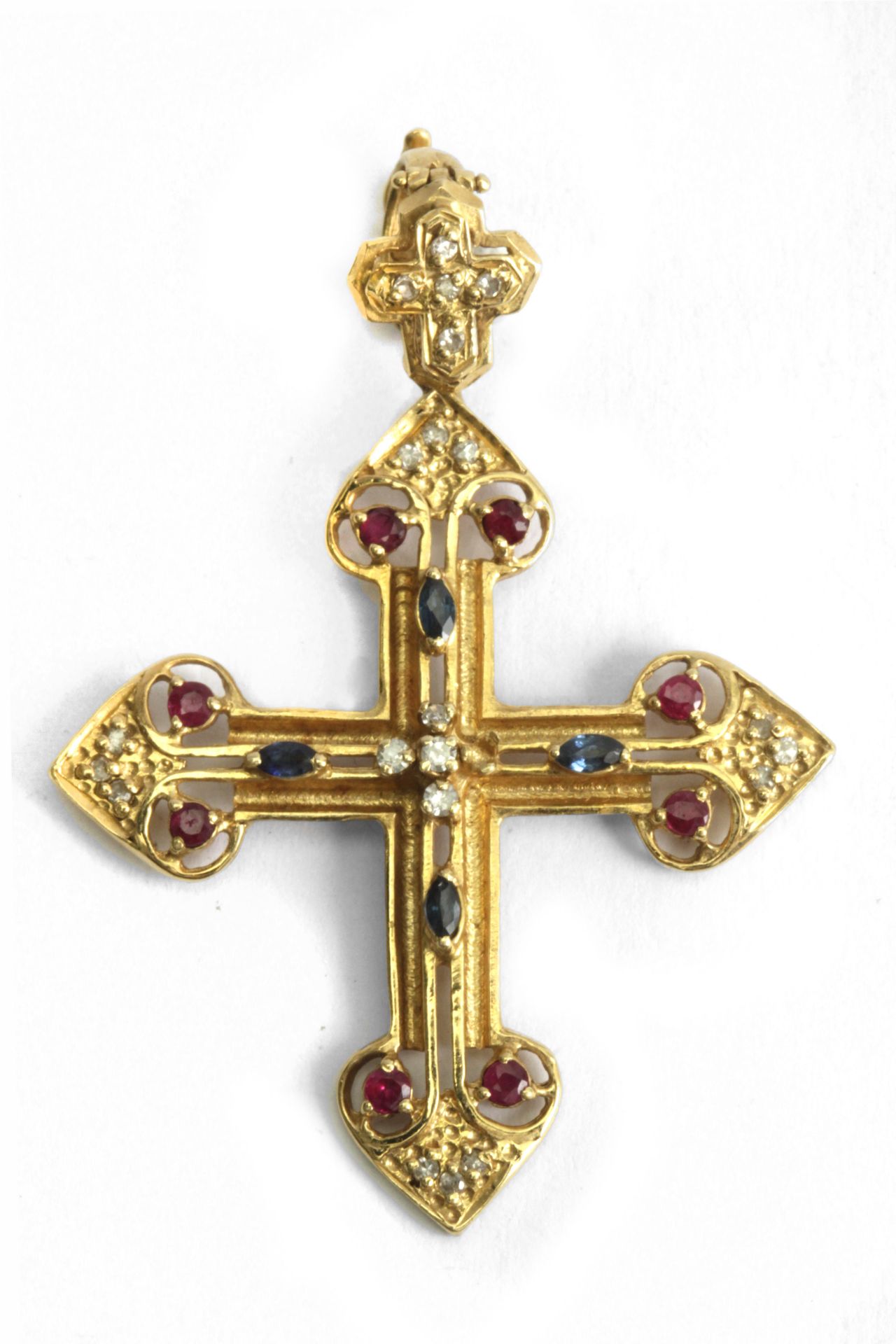 A sapphire, ruby and diamond pendant cross with an 18k., yellow gold setting