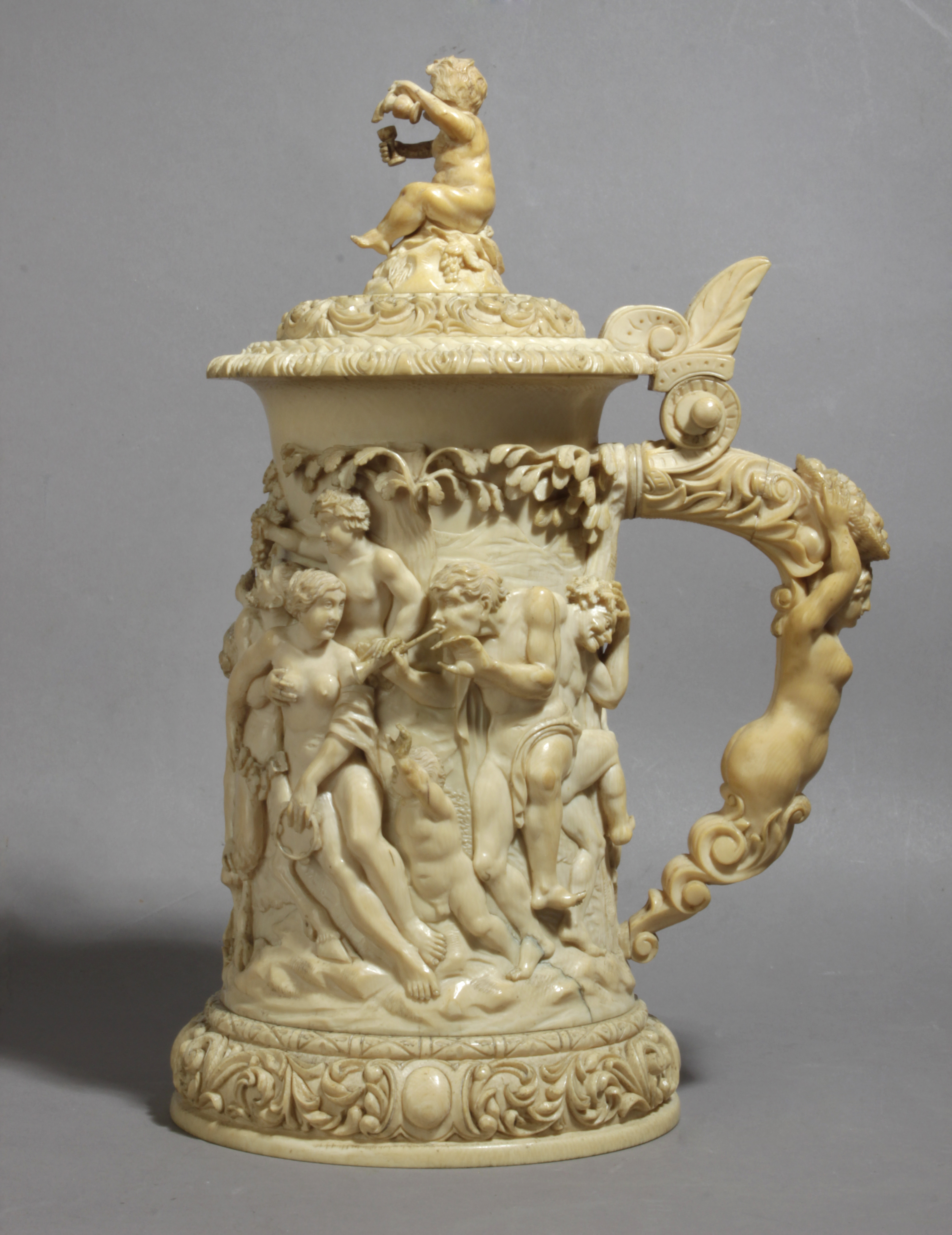 A 19th century German tankard in carved ivory depicting a Bacchanalia