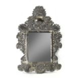 A second half of 19th century colonial mirror in embossed Mexican or Bolivian silver