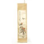 A 20th century Chinese scroll depicting roses and a bird embroidered on silk