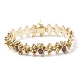 A bracelet circa 1940. With an 18k. yellow gold setting, brilliant cut diamonds and oval cut rubies