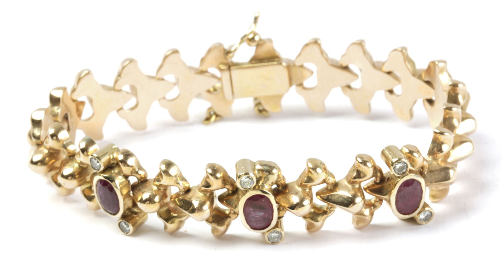 A bracelet circa 1940. With an 18k. yellow gold setting, brilliant cut diamonds and oval cut rubies