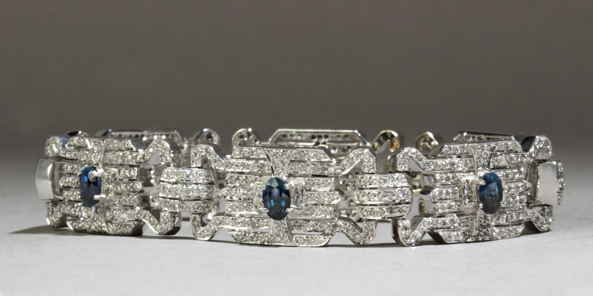 An Art-Déco style bracelet with a geometric pattern in 18k. white gold, sapphires and diamonds