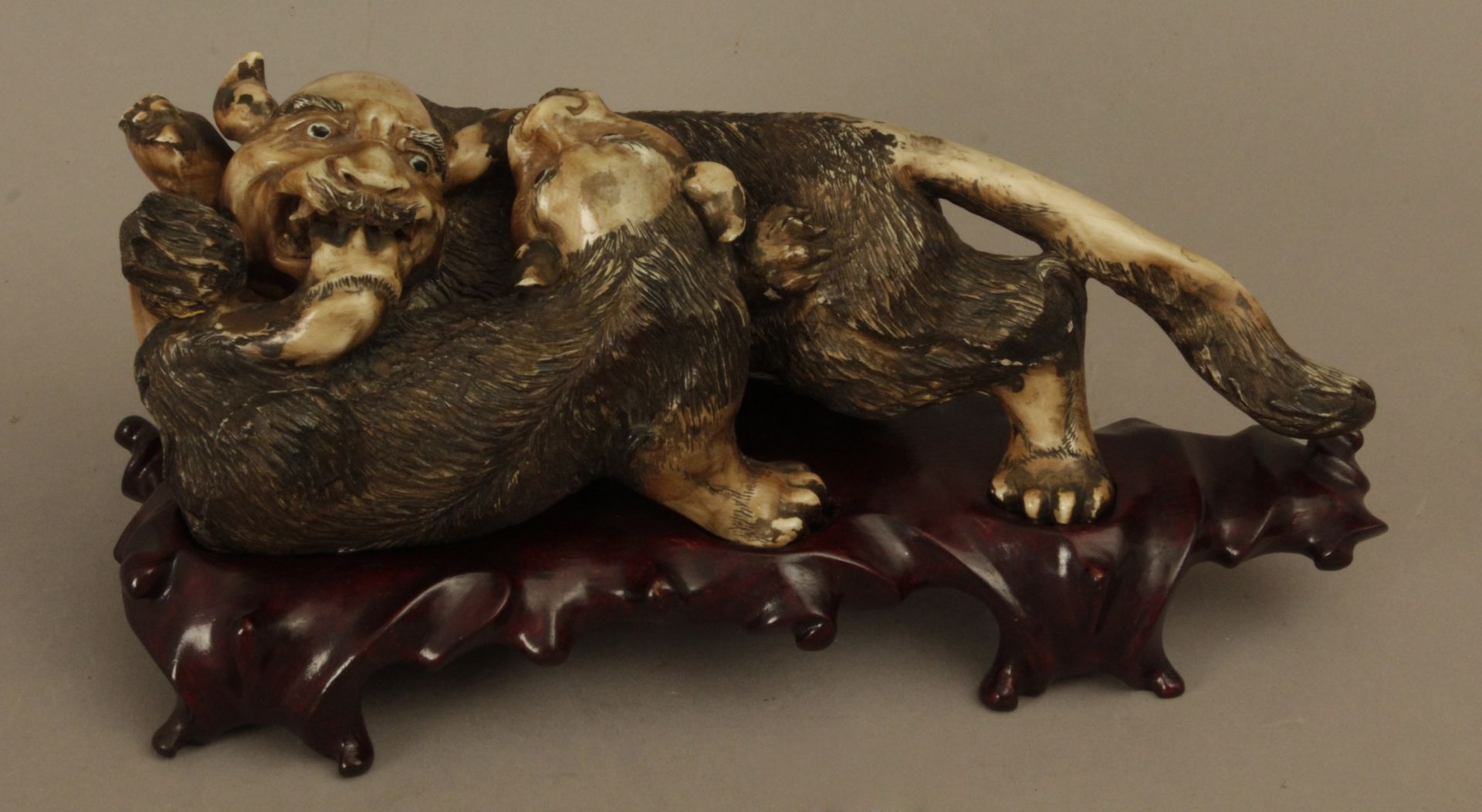 19th century Chinese school. A carved ivory sculpture portraying a pair of mythological beasts