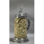 A second half 19th century German, possibly Hanau, tankard in silver and carved ivory depicting