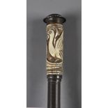 A 19th century Indian walking cane in carved wood, possibly Kalamantan