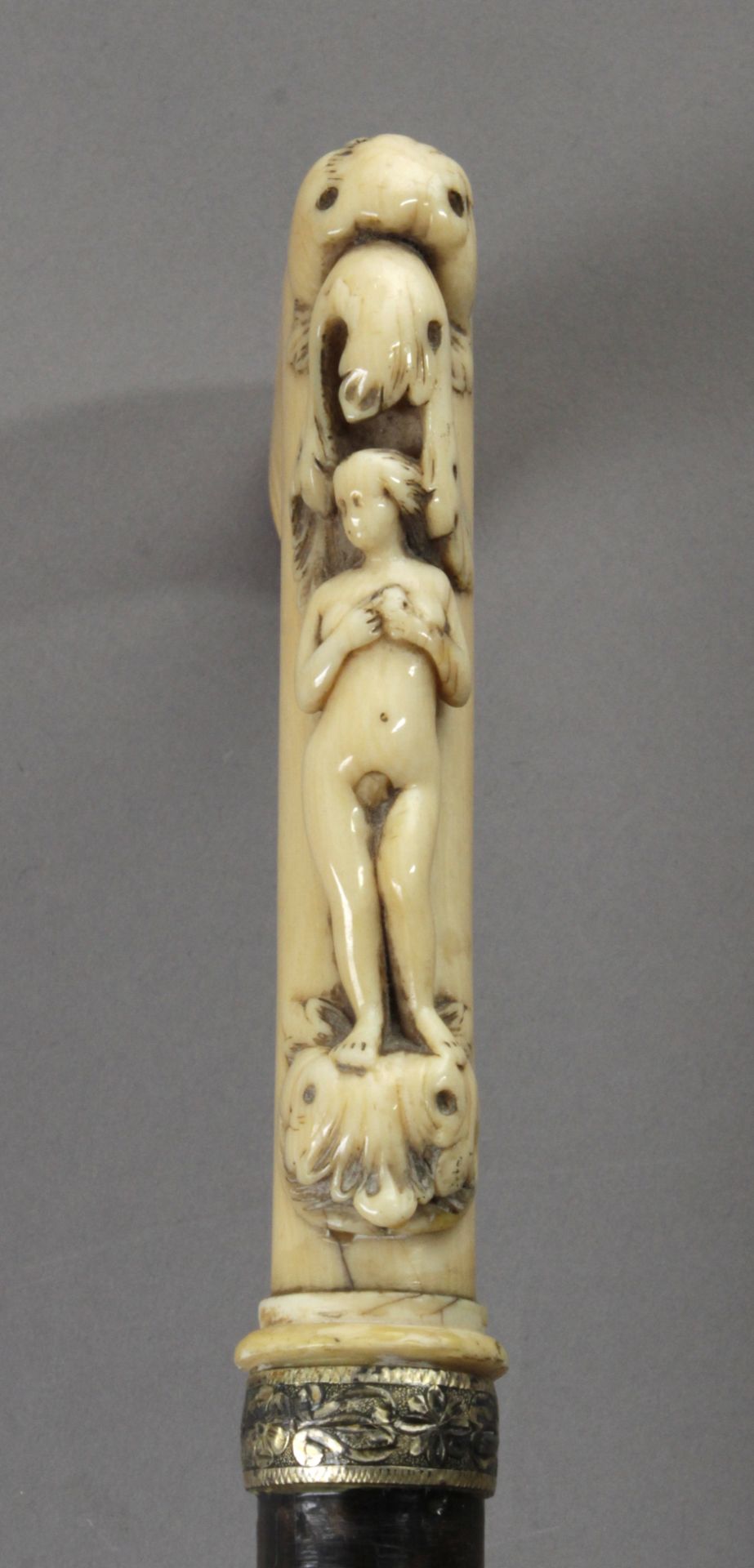 A 19th century European walking cane in carved ebony and ivory